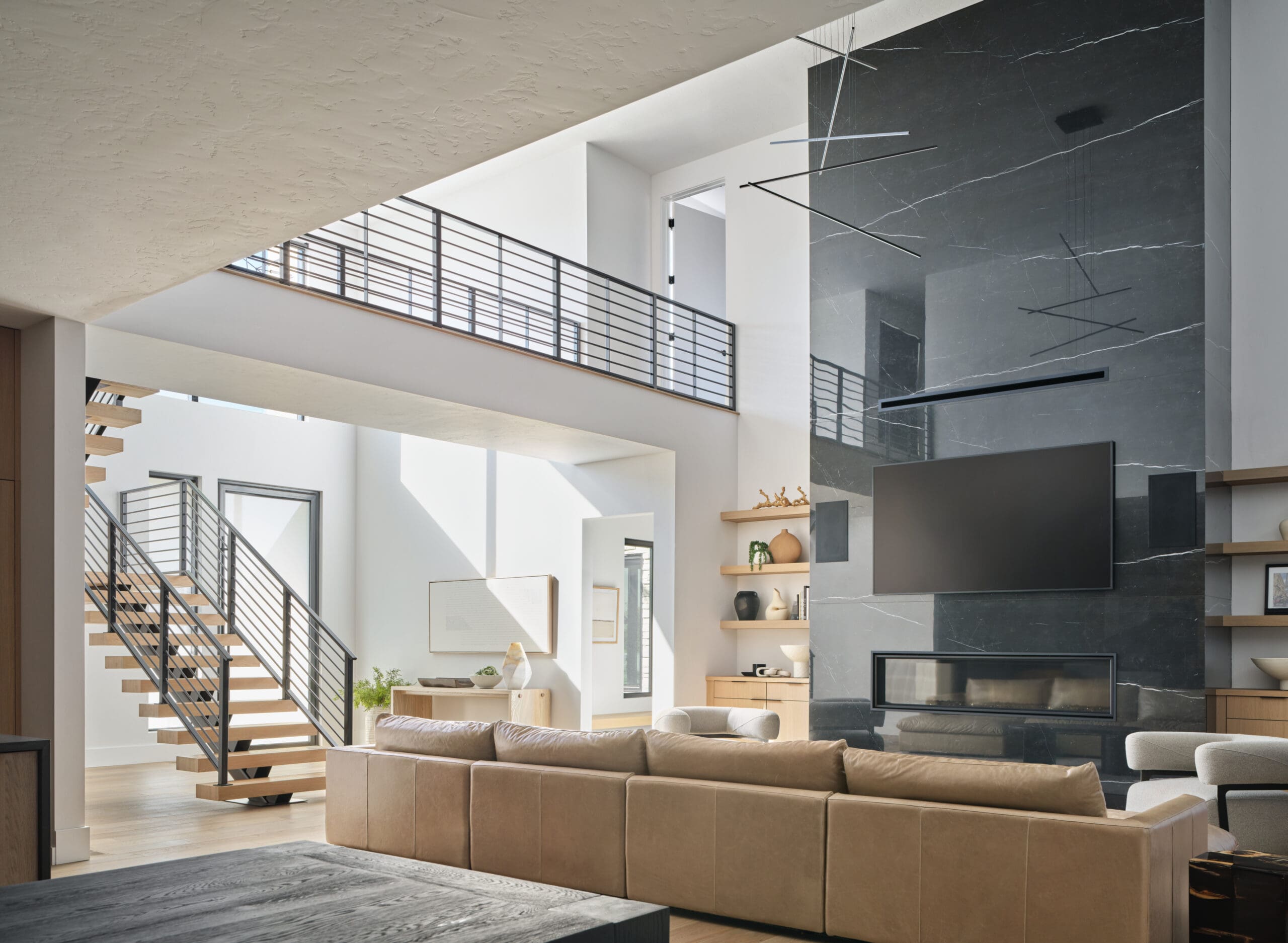 Modern family home design Eagle Idaho featuring open staircase warm wood finishes and contemporary living space by Lewis & Co